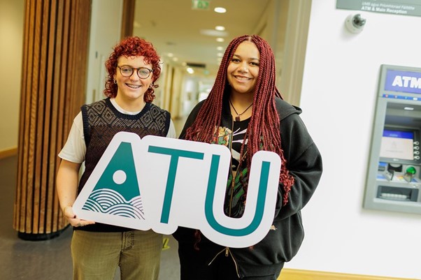 Students standing with ATU Logo