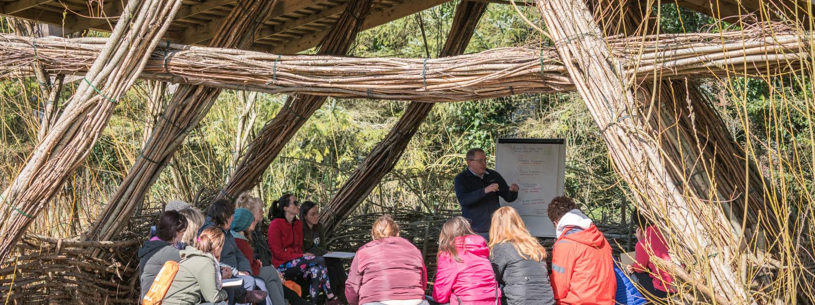 Students listening to tutor outdoors