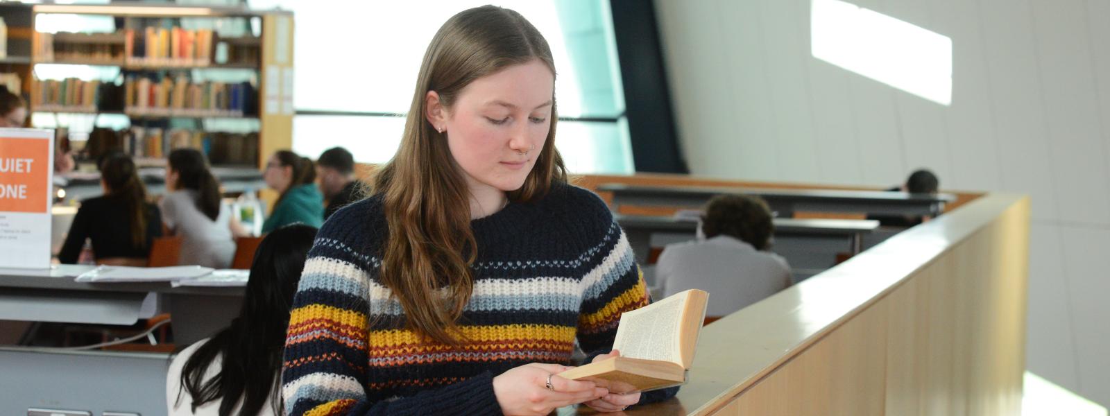 ATU Galway student reading book in library