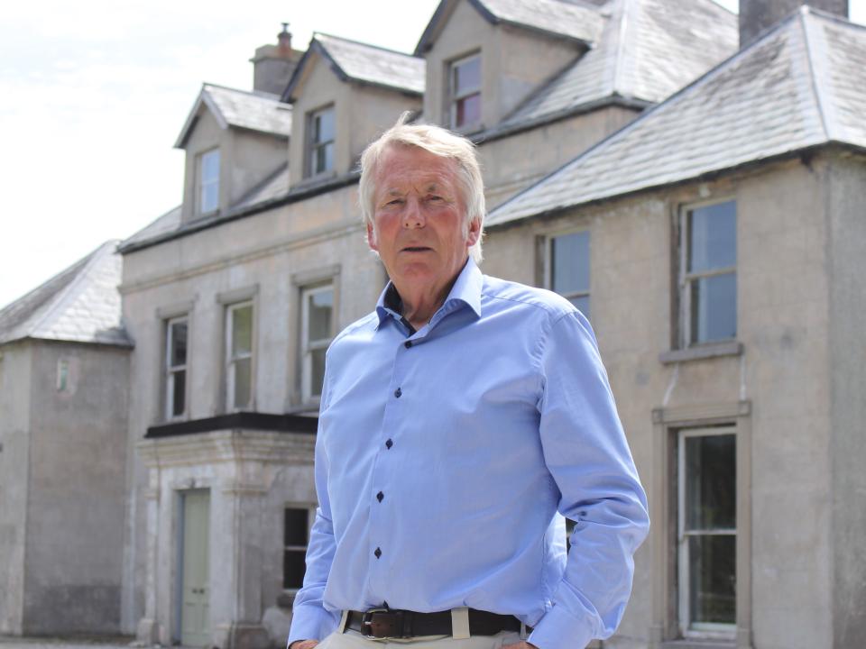 <p>Veterinary surgeon Donal Connolly, one of the three founding members of the Aleen Cust Memorial Society, pictured in front of Cordangan Manor where Aleen Cust was born in 1868</p>
